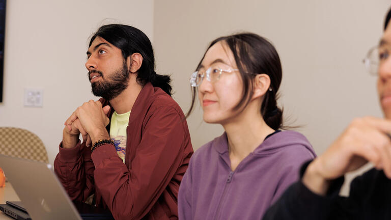 Two students paying attention in class